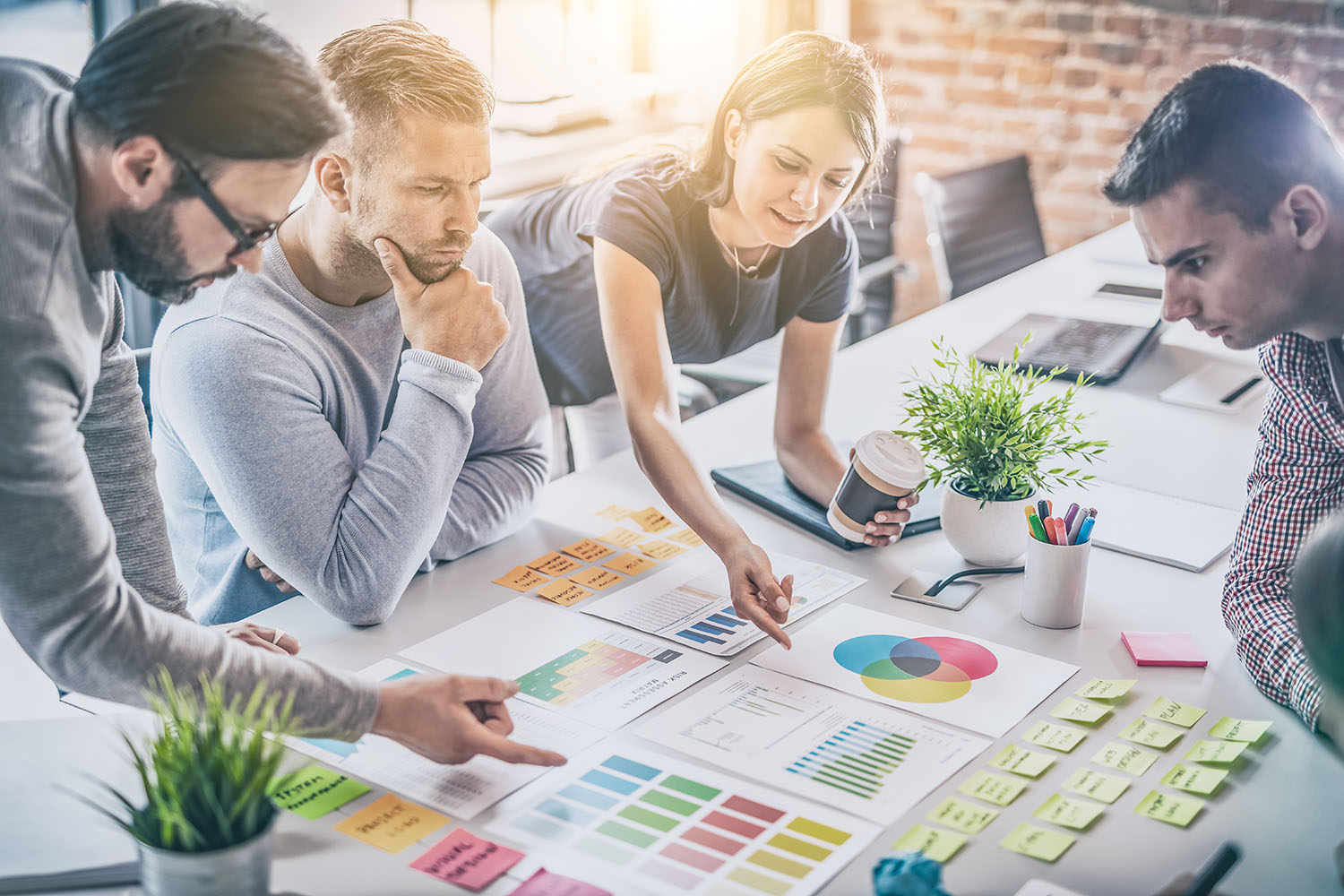 A meeting with people looking at charts and colours