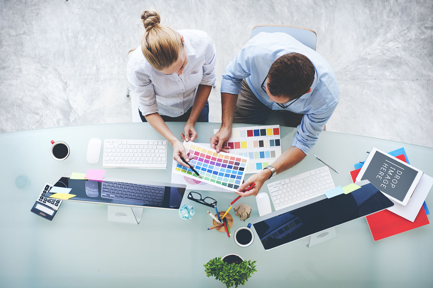 Man and woman looking at colours and computers