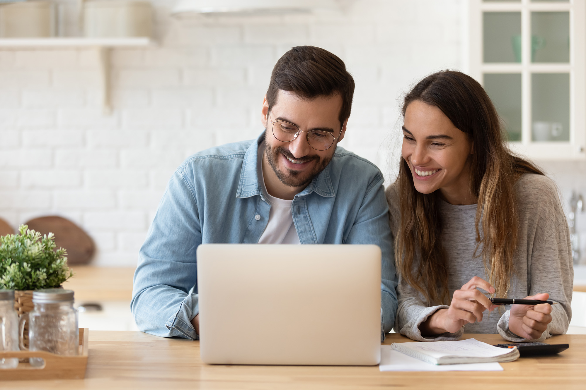 Couple looking at laptop and smiling